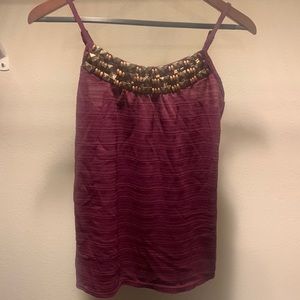 It’s from the brand Maurices. It is a size small and is purple.